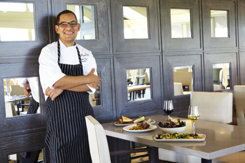 waiter serving food and wine